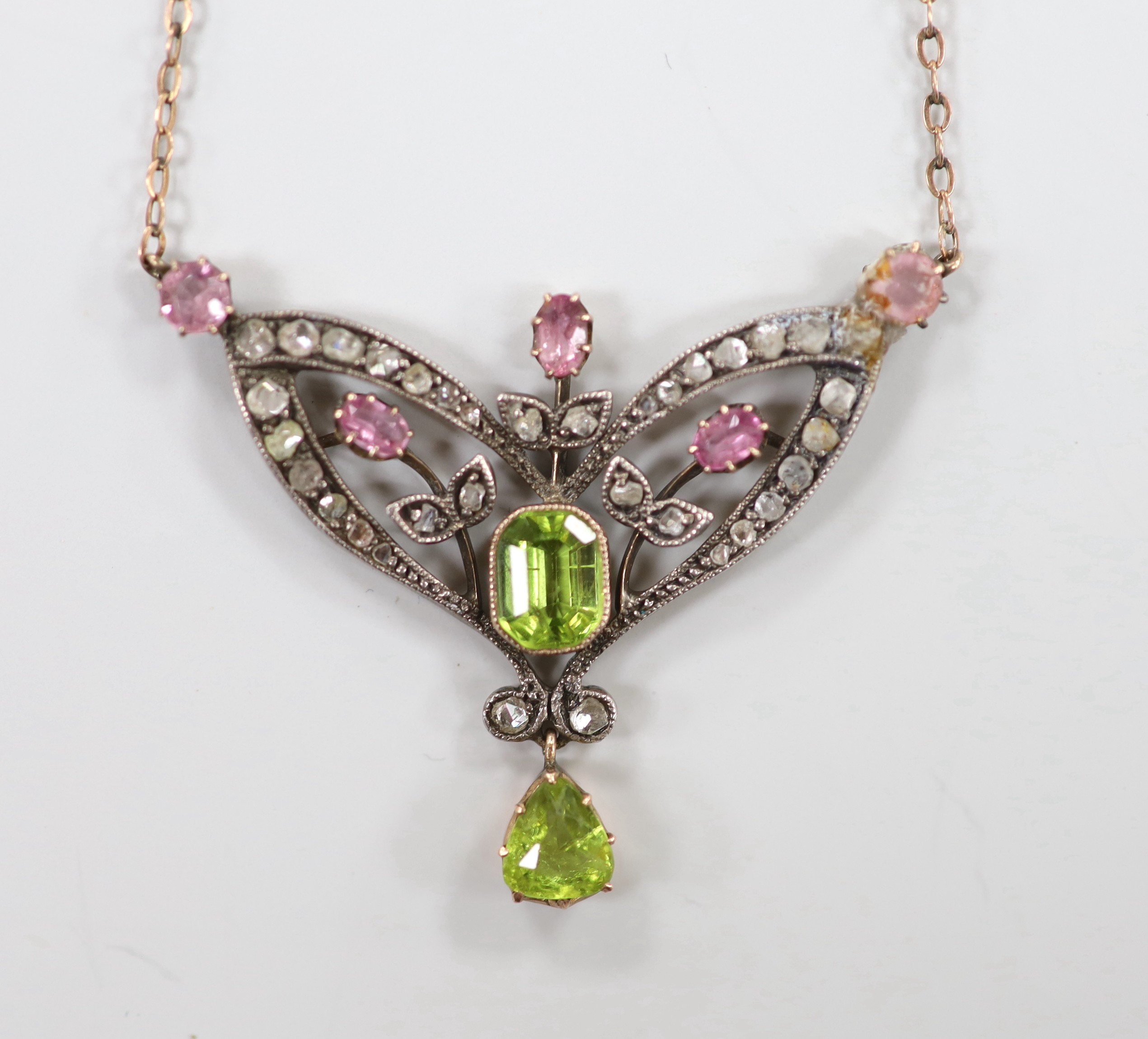 A late Victorian 9ct and white metal. peridot, pink topaz? and rose cut diamond set pendant necklace (a.f.), pendant width 44mm, chain length approx. 34cm, gross weight 7.2 grams.